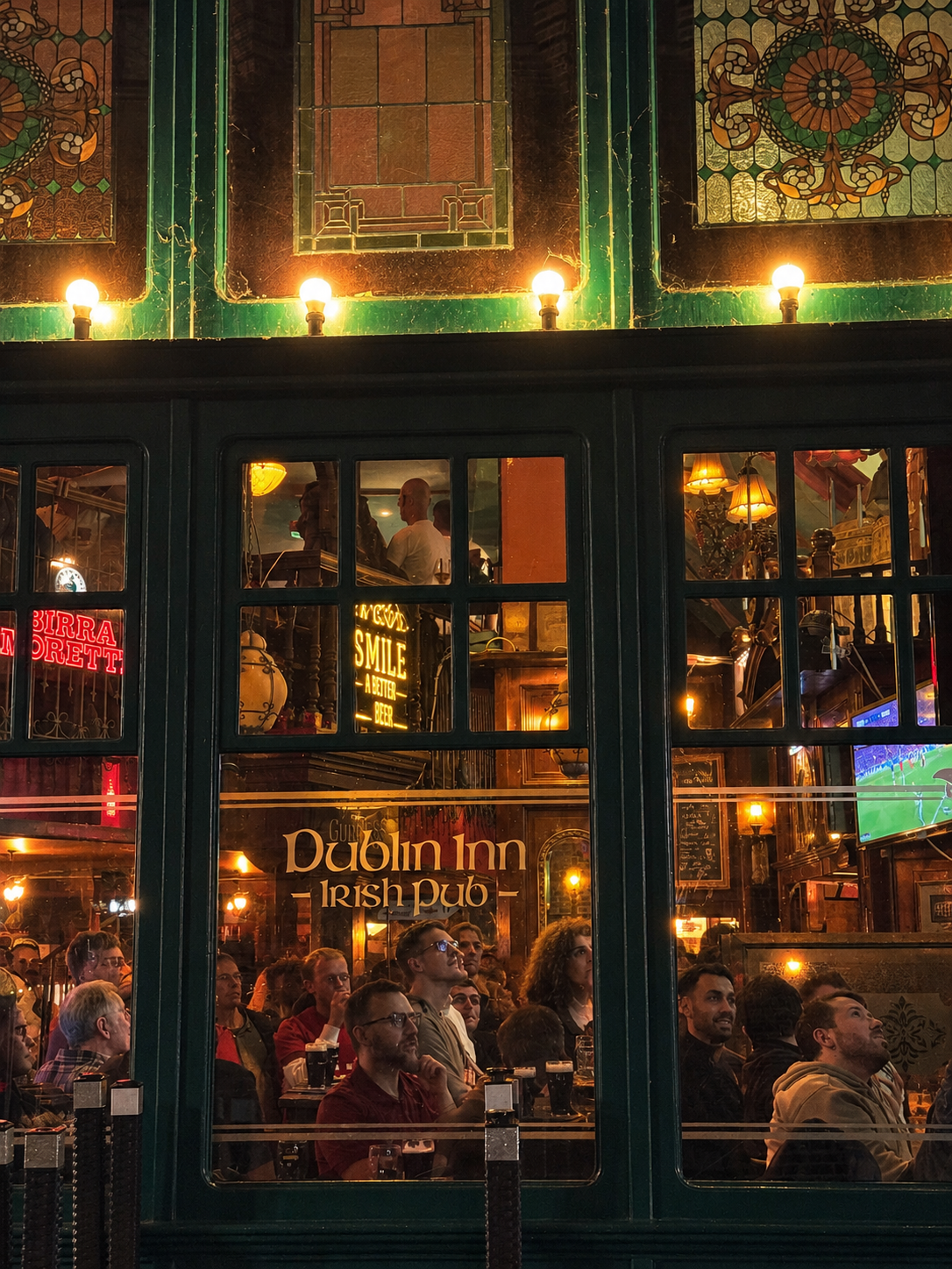 A packed football night seen through the windows of Dublin Inn Hannover