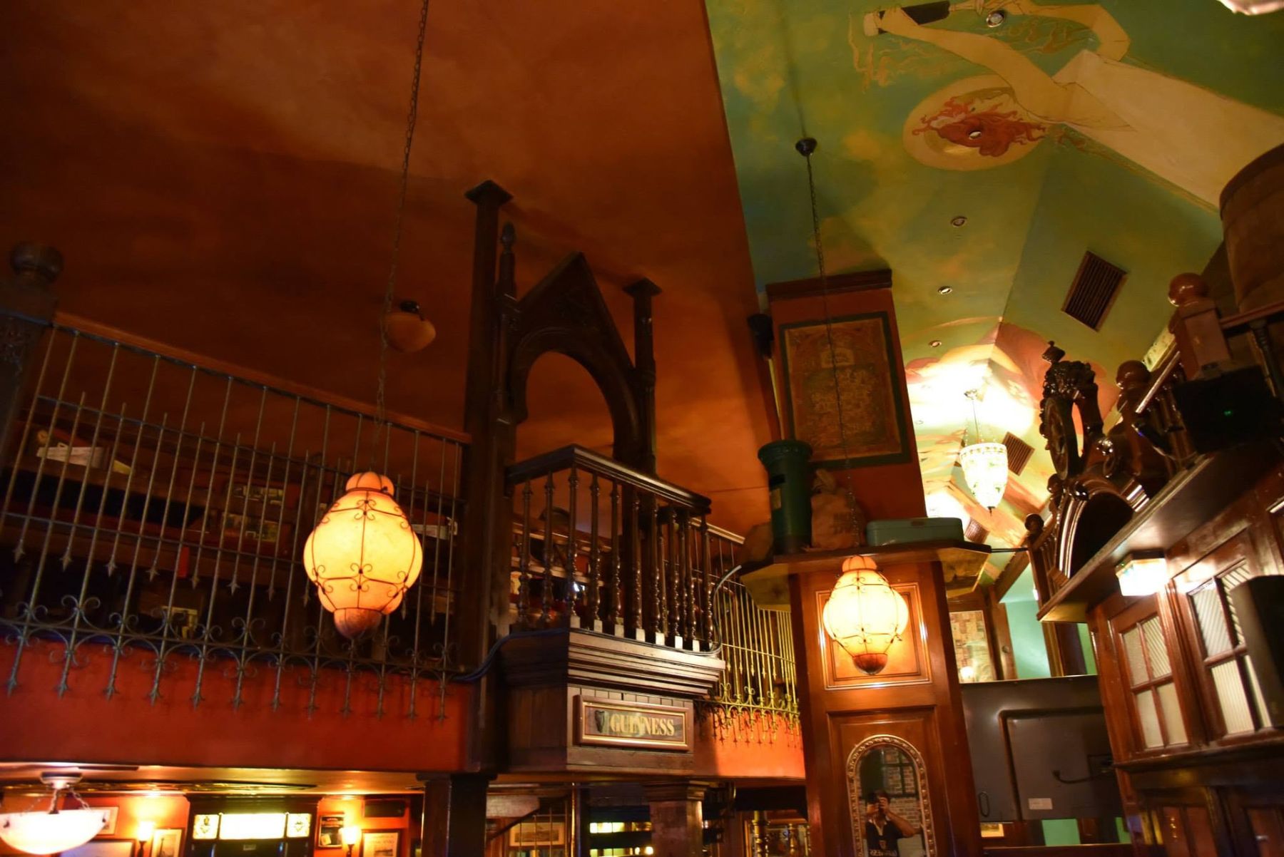 Upper gallery, historic lamps and painted ceiling inside Dublin Inn Hannover